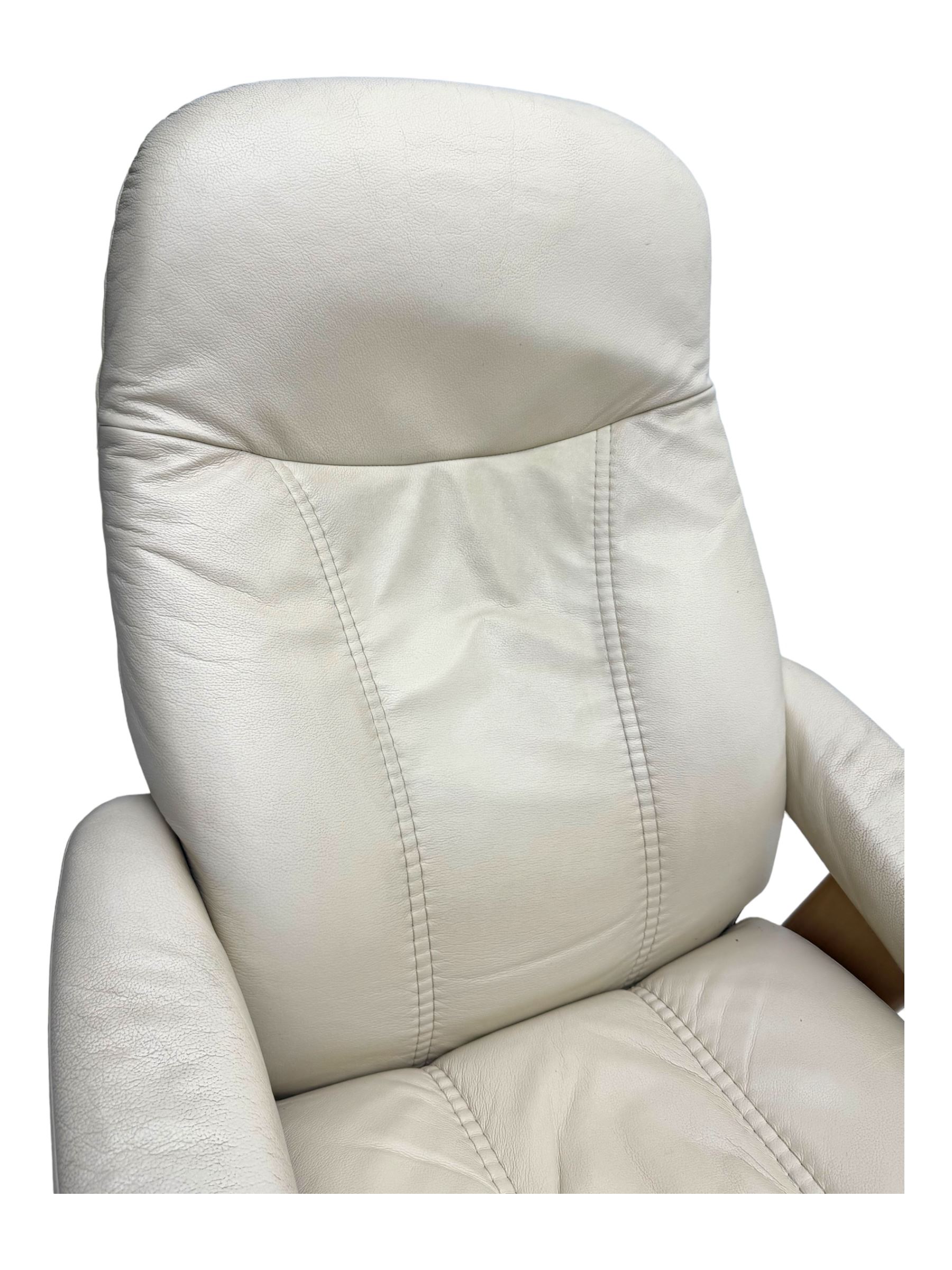 Ekornes Stressless - swivel and reclining armchair upholstered in cream leather, high back and padded armrests, raised on circular base