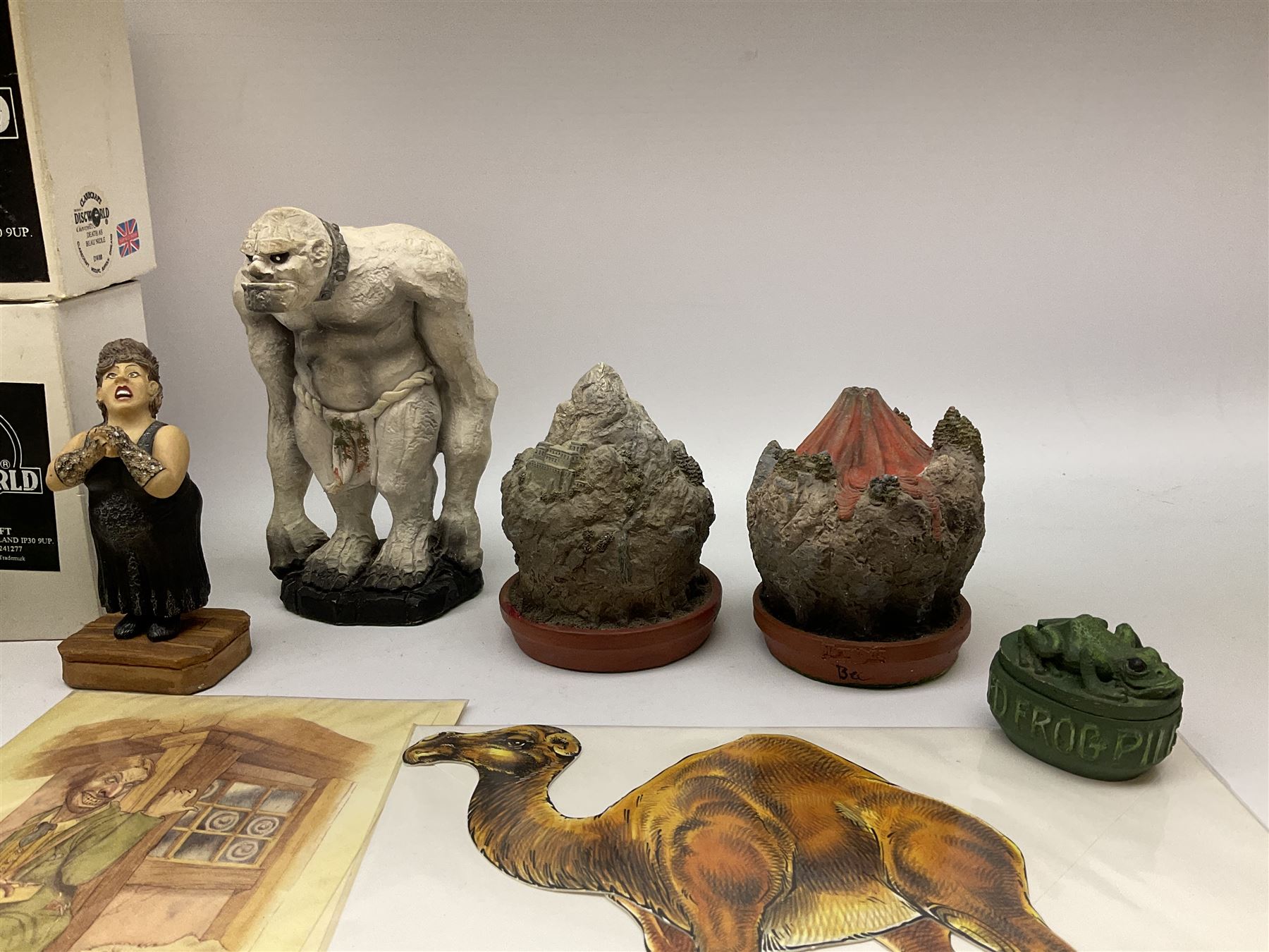 Terry Pratchett Discworld figures, designed by Clarecraft, comprising Death and Granny Weatherwax, DW90, Deathhead DWE8, Dried-frog pill box, boxed, DW63, Death as Beau Nidle, boxed, DW88, Agnes Nitt DW68, Detritus, DW22, Bonsai mountain, DW78, Volcanic bonsai mountain, boxed, DW79, Bonsai mountain valley, DW80, together with the Discworld mapp, and a collection of Terry Pratchett cards.  