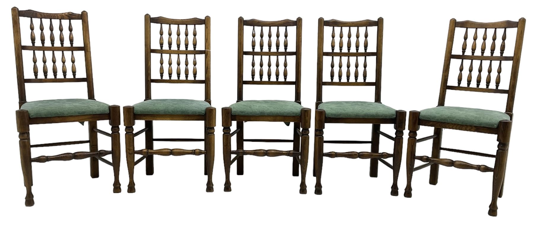 Set of five Lancashire design elm spindle back chairs, shaped cresting rail over two rows of five spindles, upholstered drop-on seats, on turned front supports united by turned stretchers  