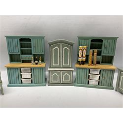 Collection of miniature dolls house furniture, to include display cabinet with pink and white floral dinner service, two serving trolleys with cakes and sweets and two blue painted kitchen dressers, together with miniature dolls house cardboard food packaging and animal figures including dogs and cats, etc