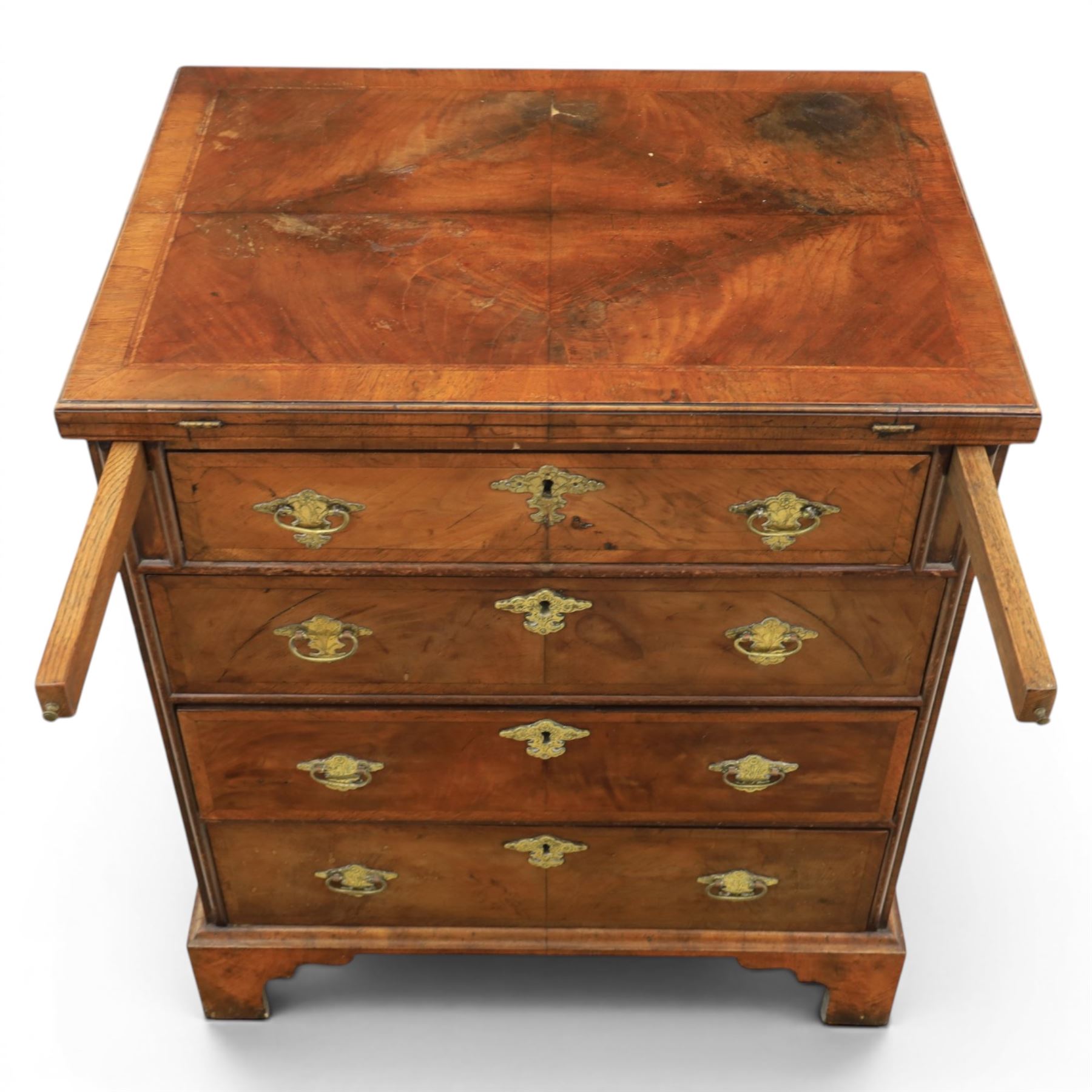 Early 20th century Georgian design figured walnut bachelor's chest, with half fold over top and lopers, over three drawers with pierced brass handles and escutcheons 