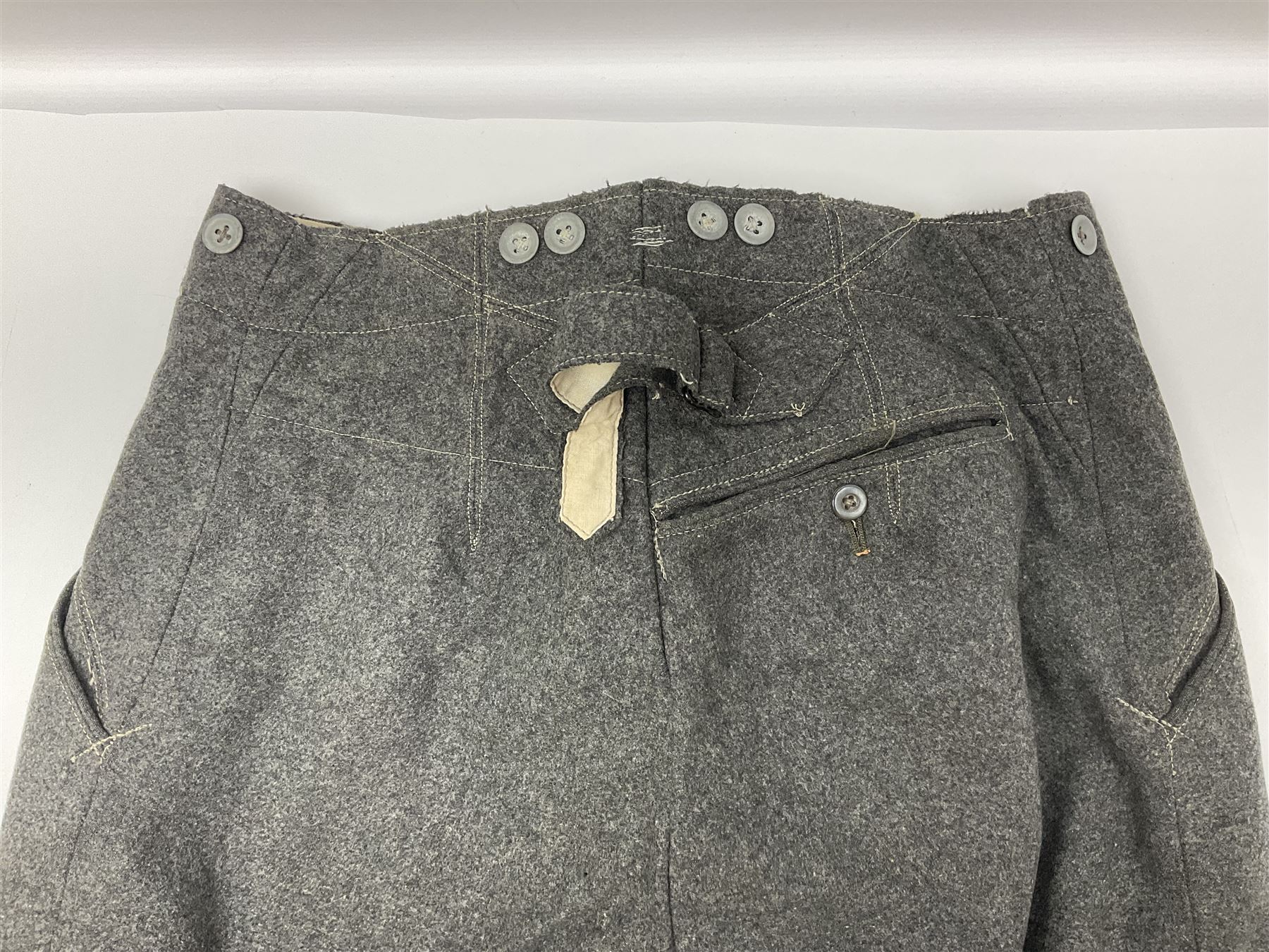 Pair of WW2 German Other Ranks trousers c1940-42, stamped C.& A. Brenninkmeyer Workstatten; WW2 German Army webbing belt with steel 'Gott Mit Uns' buckle; and WW2 German leather belt with 'Stahlhelm' (Steel Helmet League) members buckle (3)