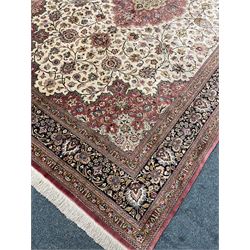 Finely knotted Persian Qom silk rug, overall pink ground with ivory field, the field with central cusped medallion profusely decorated with interlacing foliate and stylised flower heads, multiple band boarder, the main band decorated with a series of stylised motifs and trailing foliage, the outer guard with signature panel 