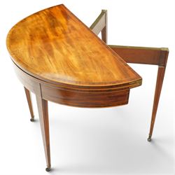 George III inlaid mahogany demi-lune card table, the hinged lunette top inlaid with satinwood stringing and crossbanding, opening to reveal a baize line interior, banded frieze over single gate-leg action and square tapering supports with castors
Provenance: Kirkham Hall