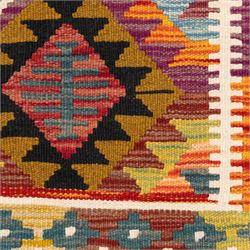 Afghan kilim rug, the field in earthy tones decorated with columns of repeating lozenges with further geometric motifs, the teal guard band with repeating stepped lozenges heightened with ivory
