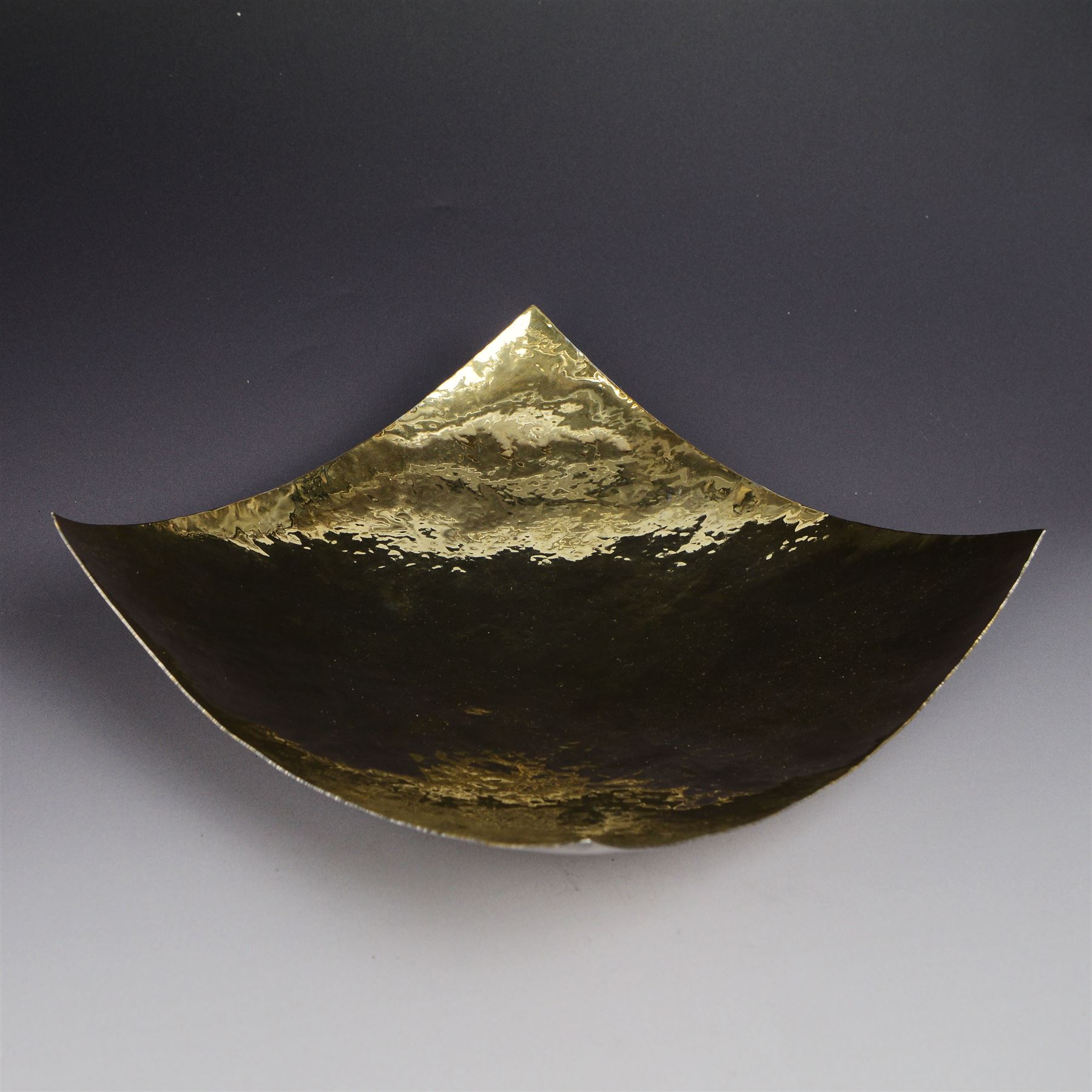 Modern silver bowl, of square concave form, with gilt interior and gilt spiral decoration to underside, with planished decoration throughout, upon four column feet, hallmarked Jonathan Braganza, London 2013, H5cm, W18cm