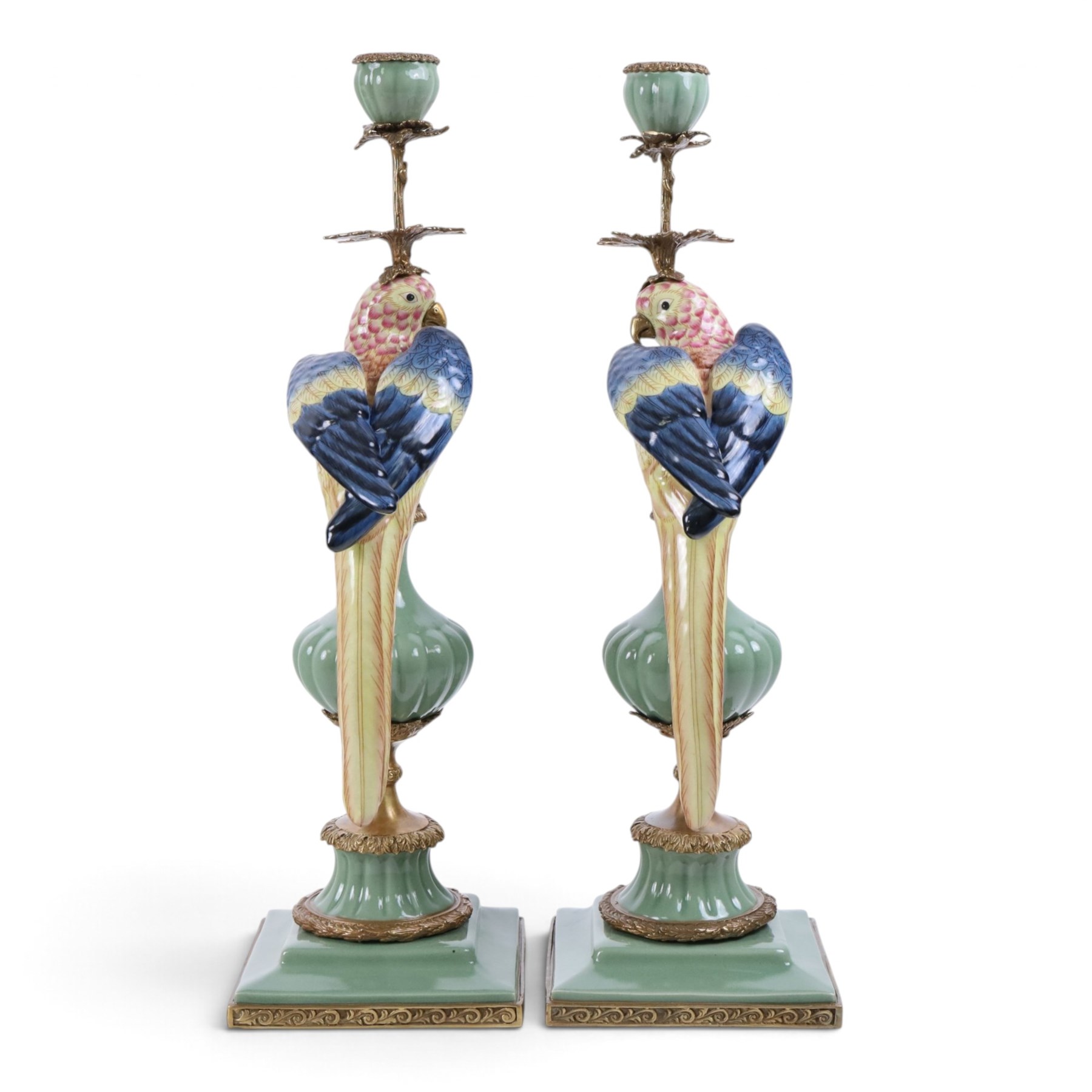 Pair candlesticks, modelled as parrots, upon urn shaped mounts with gilt detail, H48cm