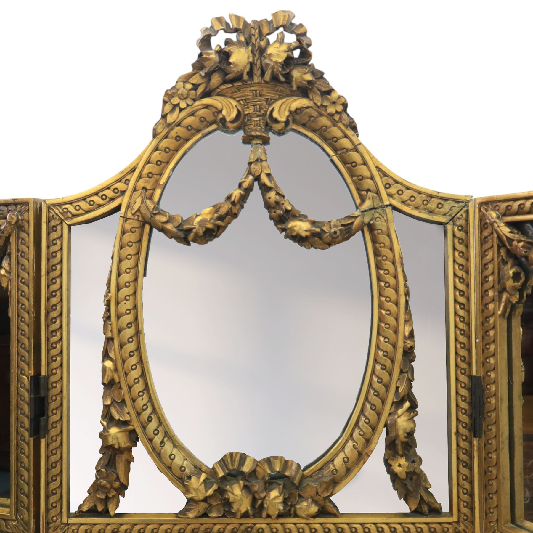 Late 19th century French Louis XIV style giltwood three fold dressing screen, each panel upholstered in floral fabric within fluted borders, with mirrored panels to tops set within moulded frames with foliate and ribbon swags 
