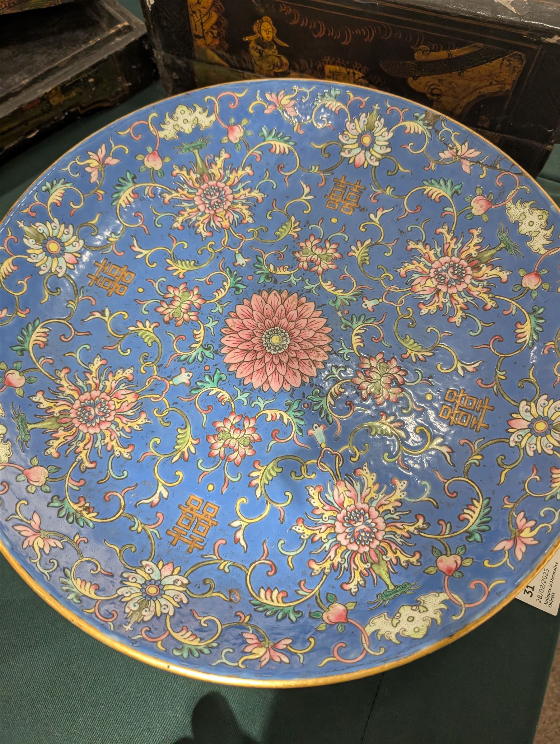 20th century Chinese footed bowl, of circular form, decorated in polychrome enamels with flowers and foliage on a cobalt blue ground, upon three grotesque mounted feet, with character marks beneath, H13cm, D38cm