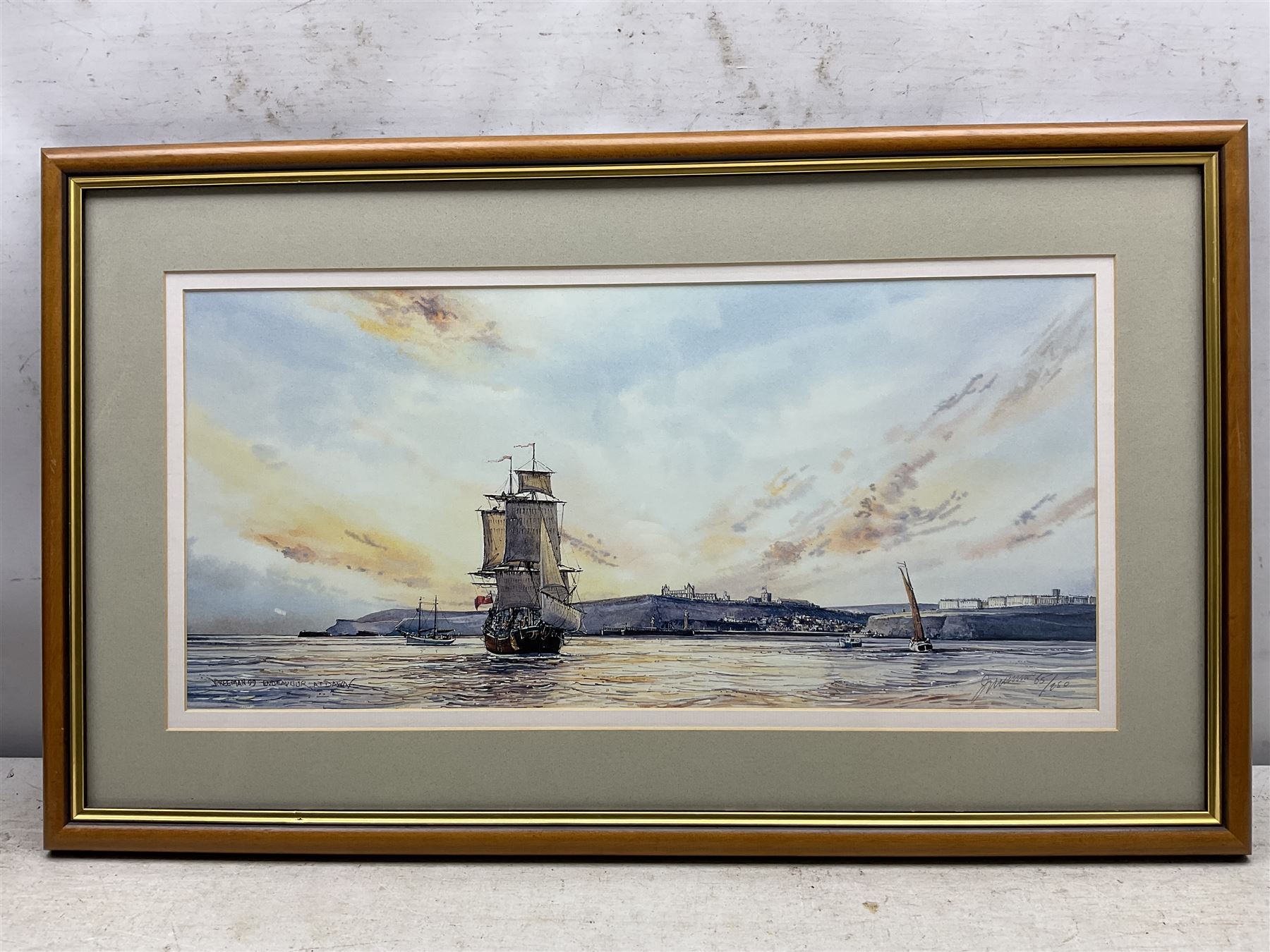 John Freeman (British 1942-): Snow on the Moors, watercolour and ink signed and dated '00, 10cm x 15cm; together with 'Endeavour at Dawn' off Whitby, limited edition print signed and numbered 65/250 in pencil 23cm x 49cm (2)