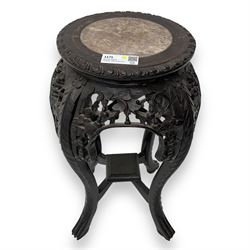 Late 19th century Chinese hardwood pedestal stand, circular top with inset marble panel, carved apron with openwork foliate and floral motifs, raised on cabriole supports with stylised claw and ball feet united by square undertier