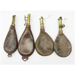 Four Victorian leather and brass shot flasks; Victorian copper powder flask embossed with stags in a landscape (lacking nozzle); and reproduction American style brass and copper powder flask (6)
