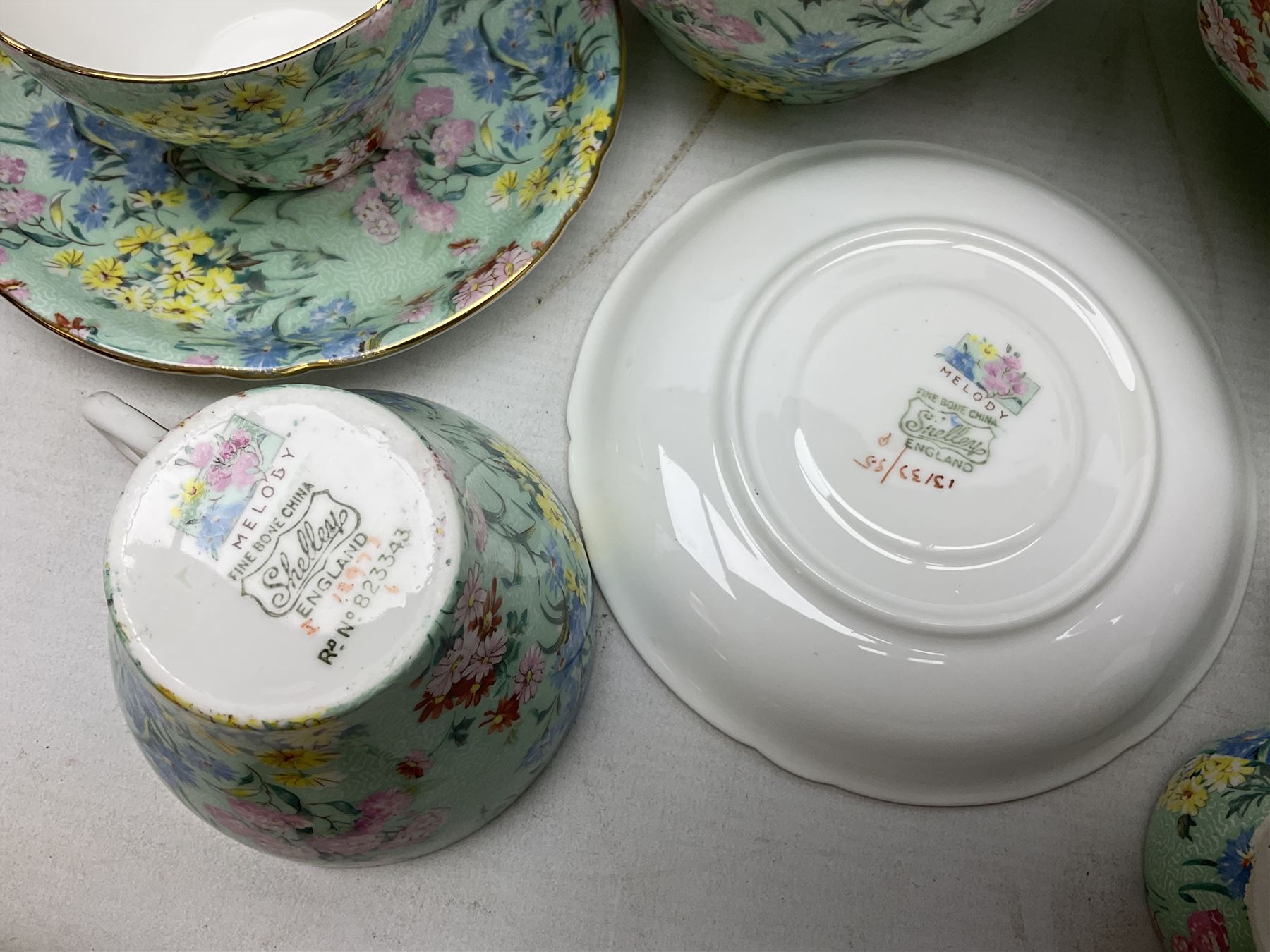 Shelley Melody pattern tea service for six, to include teapot, teapot stand, hot water jug, milk jug, covered sucrier, teacups and saucers, cake plates etc (31)