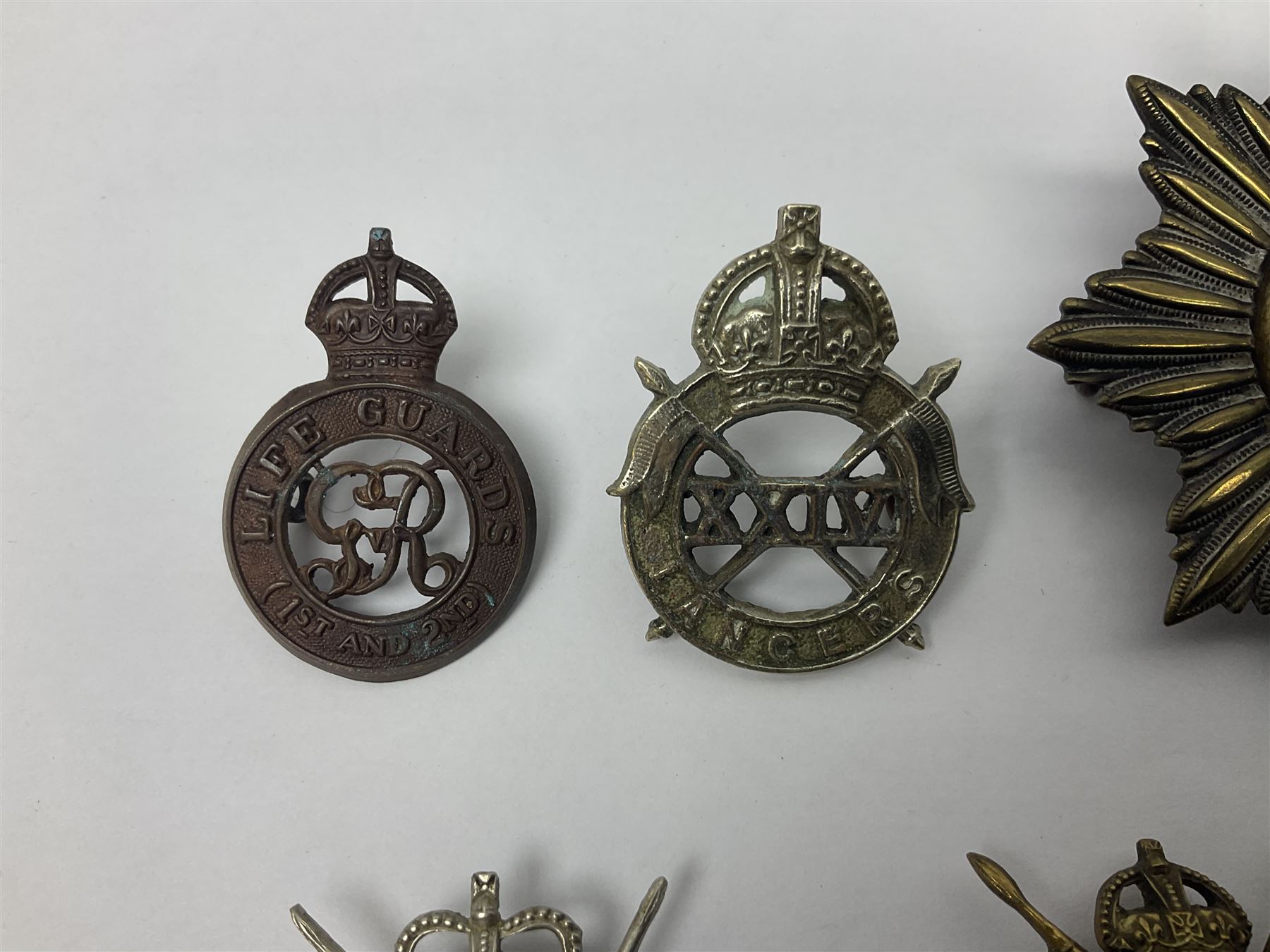 Nine Lancers metal cap badges including 9th, 12th Royals, 24th, 16th Queens and 17th; together with eight various Guards/Dragoons badges (17)