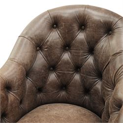 Georgian design tub-shaped club armchair, upholstered in back-buttoned dark tan leather with sprung seat, raised on square tapering supports with brass cups and castors
