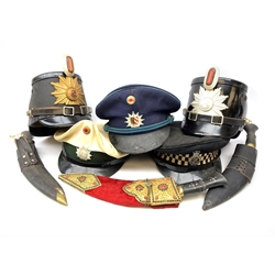 Four various 20th century German police hats; peaked cap with Metropolitan Police badge; and three kukri knives