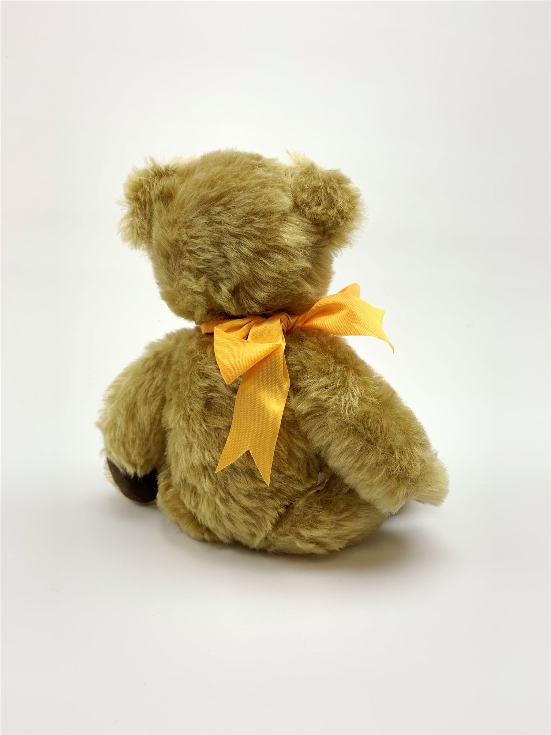 Chad Valley Hygienic Toys teddy bear c1950, kapok filled mohair plush body with original factory given yellow neck ribbon, jointed limbs with velvet paw pads, glass eyes and vertically stitched nose and mouth, blue/white printed label to side seam H12