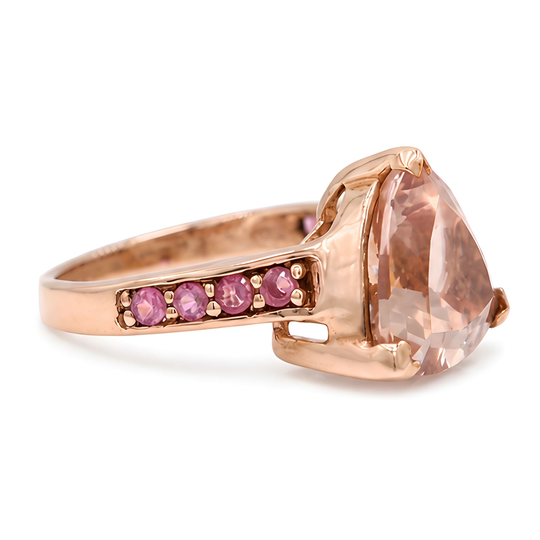 9ct rose gold morganite and tourmaline ring, single trilliant cut morganite of approx 5.35 carat, each shoulder set with four round cut tourmalines, Birmingham 2011
