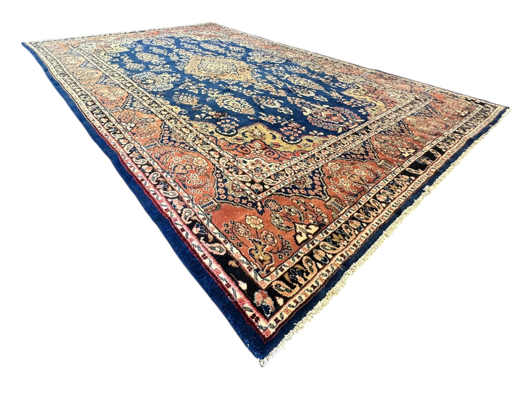 Persian Herati design indigo and red ground carpet, decorated with floral motifs, arched border