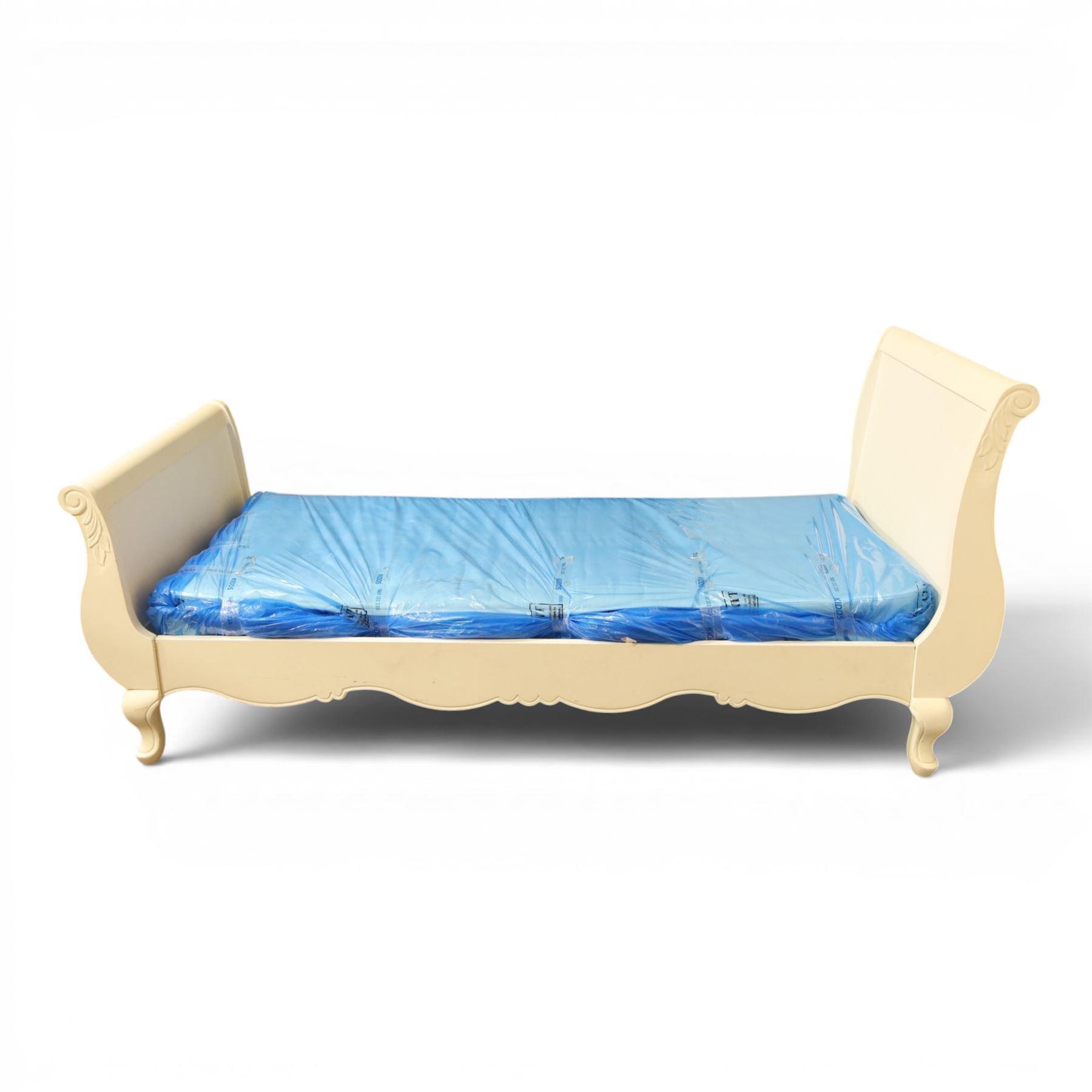 Modern white painted single sleigh bed frame and mattress, with scrolled head and footboard with foliage detail