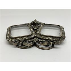 Early 19th century silver plated double photograph frame, each rounded rectangular aperture surrounded by a paste border, with ornate scroll feet and mantling also set with clear paste stones, with easel style support verso, H12cm