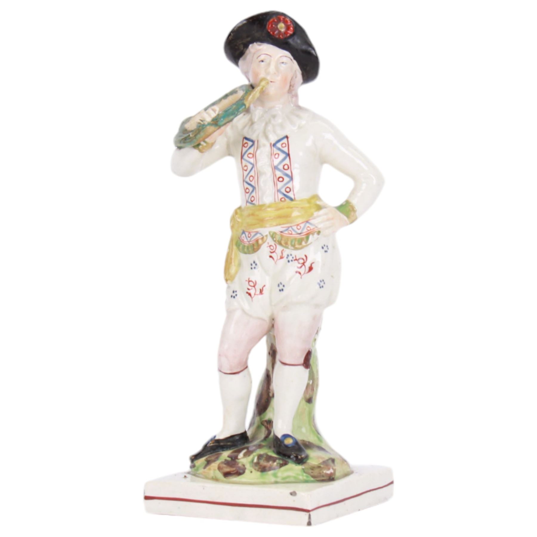 Pair of early 19th century Staffordshire pearlware figures, modelled as musicians, he playing the French horn, she the tambourine, each upon square plinth, tallest example H23cm