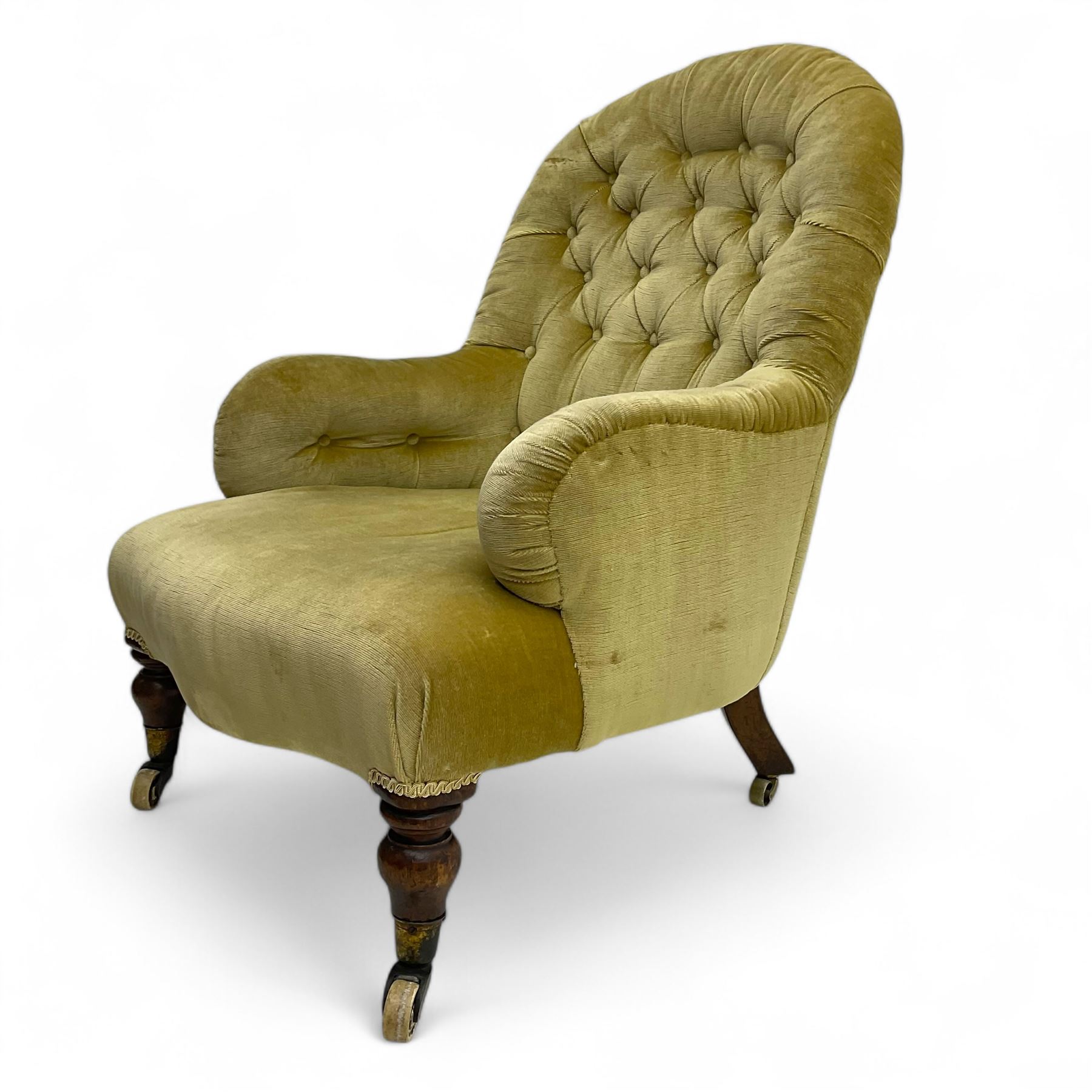 Late 19th century button-back nursing chair, upholstered in olive-green velvet, shaped back with padded arms, raised on turned front supports terminating in castors