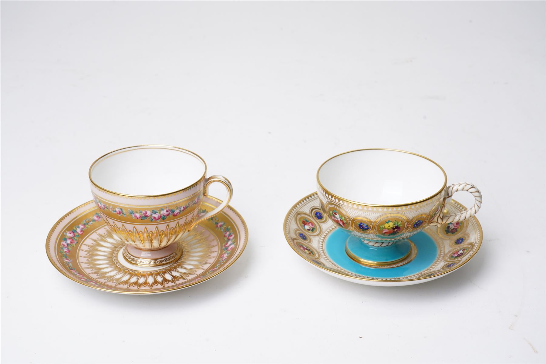Brown-Westhead, Moore & Co cabinet cup and saucer, with rope twist moulded handle, hand-painted with floral reserves against a white and sky blue ground, heightened profusely with gilt, together with a pink hand-painted example, and a 19th century spill vase and twin-handled covered sucrier (4)