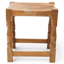 Mouseman - 1950s dark oak dressing table stool, the rectangular top with tan leather seat, raised on octagonal supports united by box stretcher, carved with mouse signature, by the workshop of Robert Thompson of Kilburn