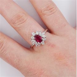 18ct white gold ruby and diamond cluster ring, the oval cut ruby of 0.86 carat, with marquise cut and round brilliant cut diamond surround, London 2004, total diamond weight 0.65 carat 