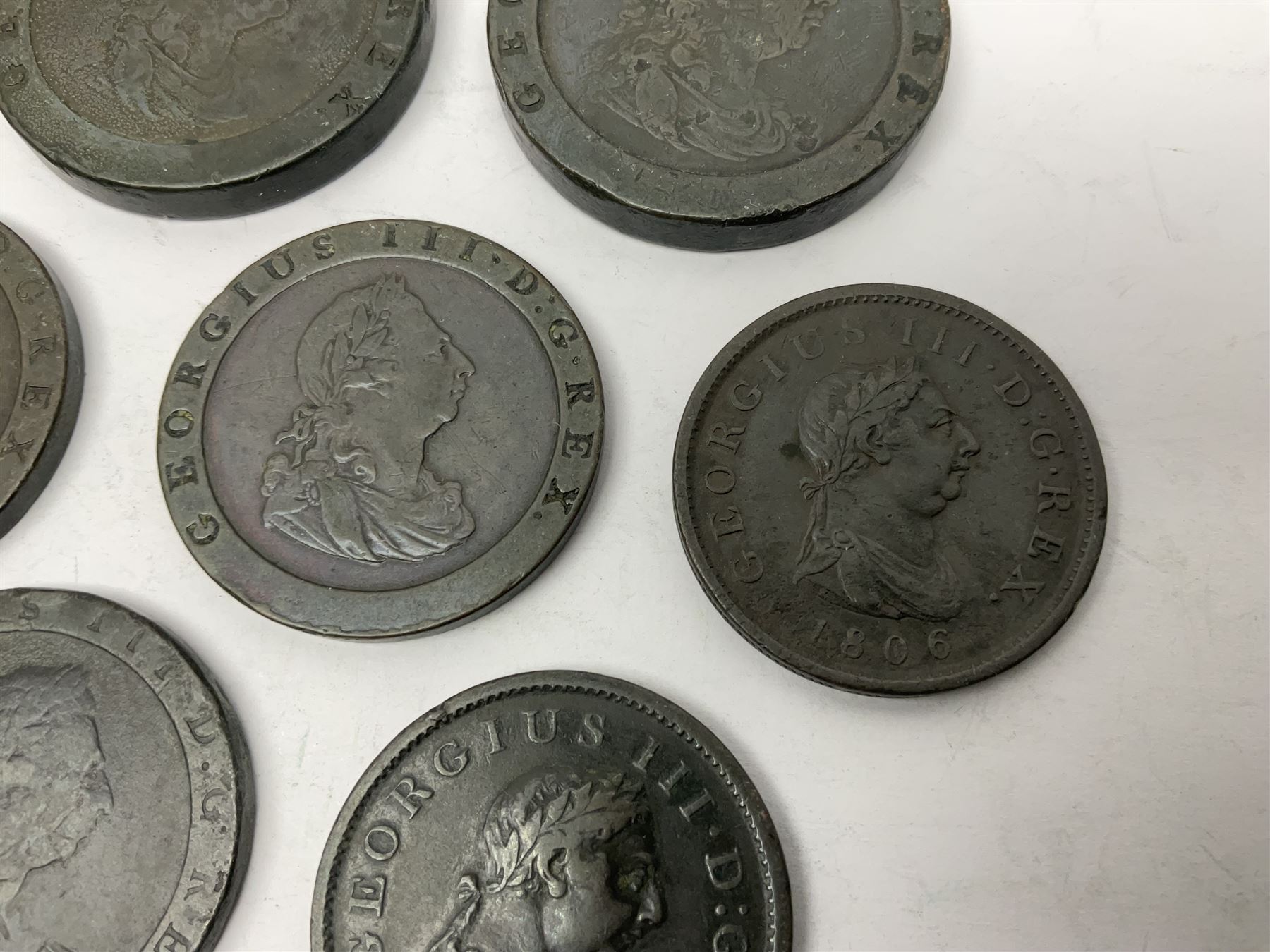 Two George III halfpenny coins dated 1799 and 1806, four pennies dated three 1806 and 1807, four 1797 cartwheel pennies and three 1797 cartwheel two pence coins