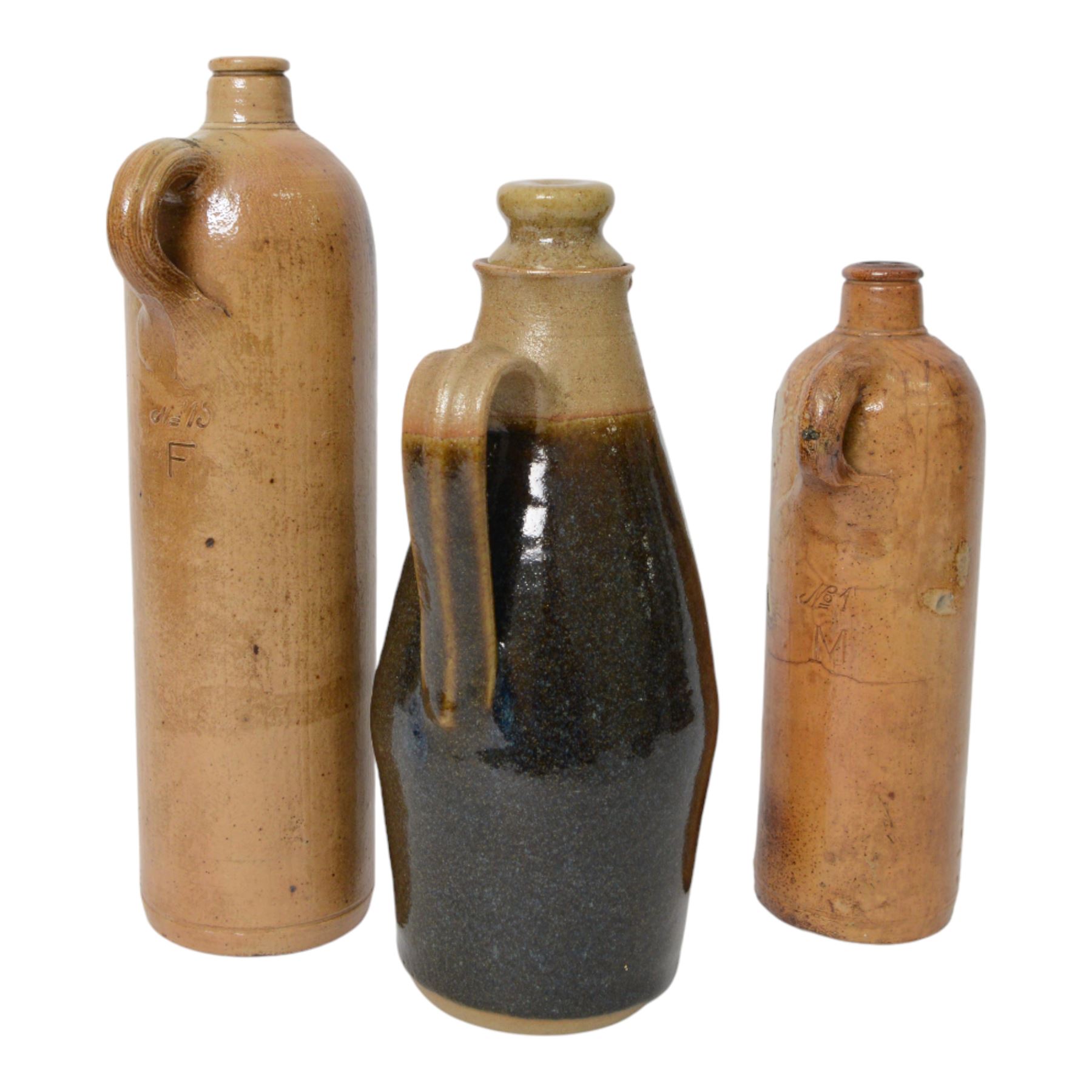 British, a stoneware jug and cover in the manner of Richard Batterham, together with two  stoneware gin flagons 