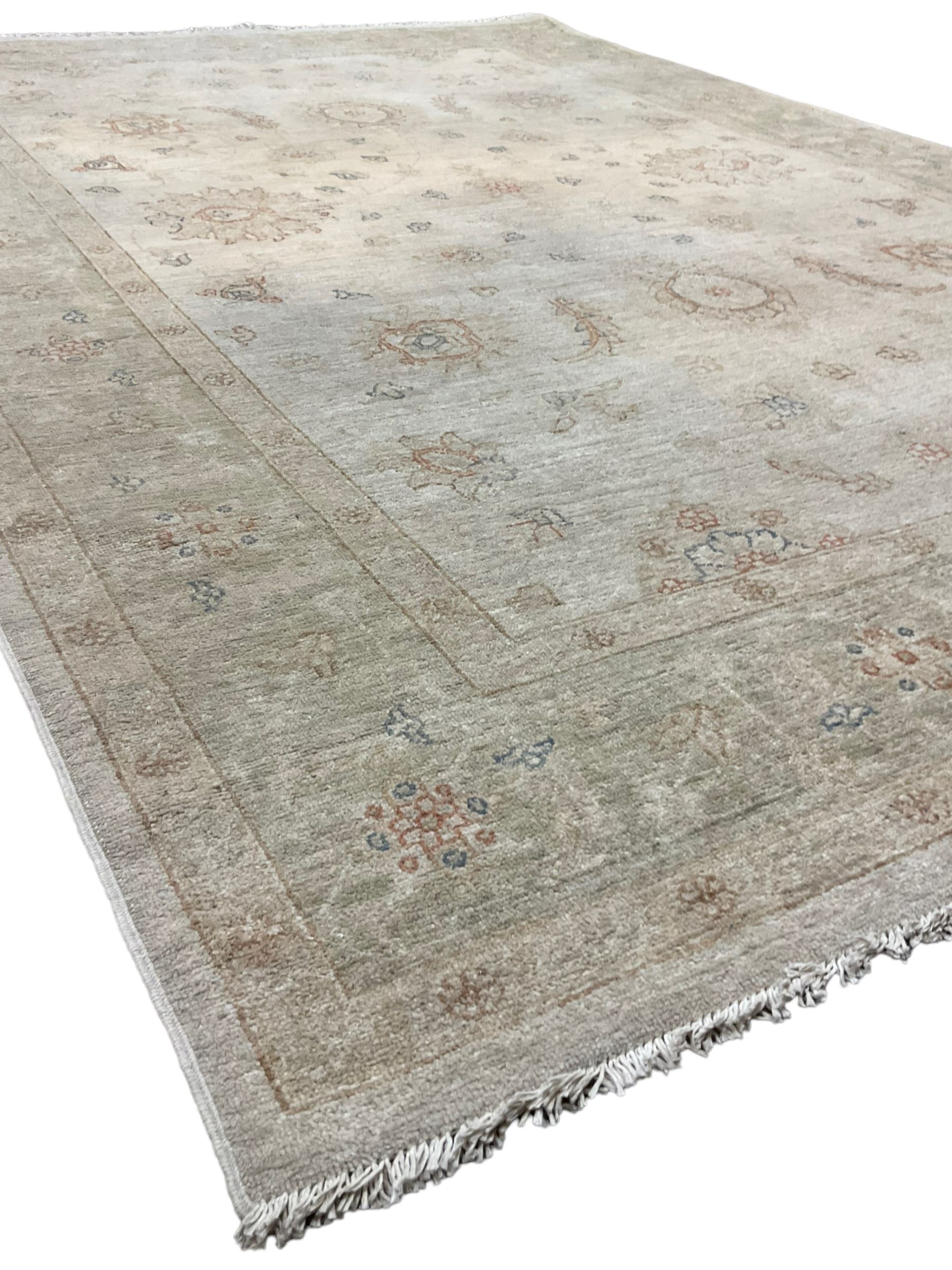 Persian Zeigler rug, ivory ground and decorated with stylised plant motifs, floral design border