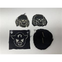 Collection of eleven German metal and cloth badges and uniform buttons including driver's badge, two 'SS' fabric skulls, private's shoulder tabs, Police cloth badge, tank destruction badge, medal bars and ribbon etc; most WW2 period
