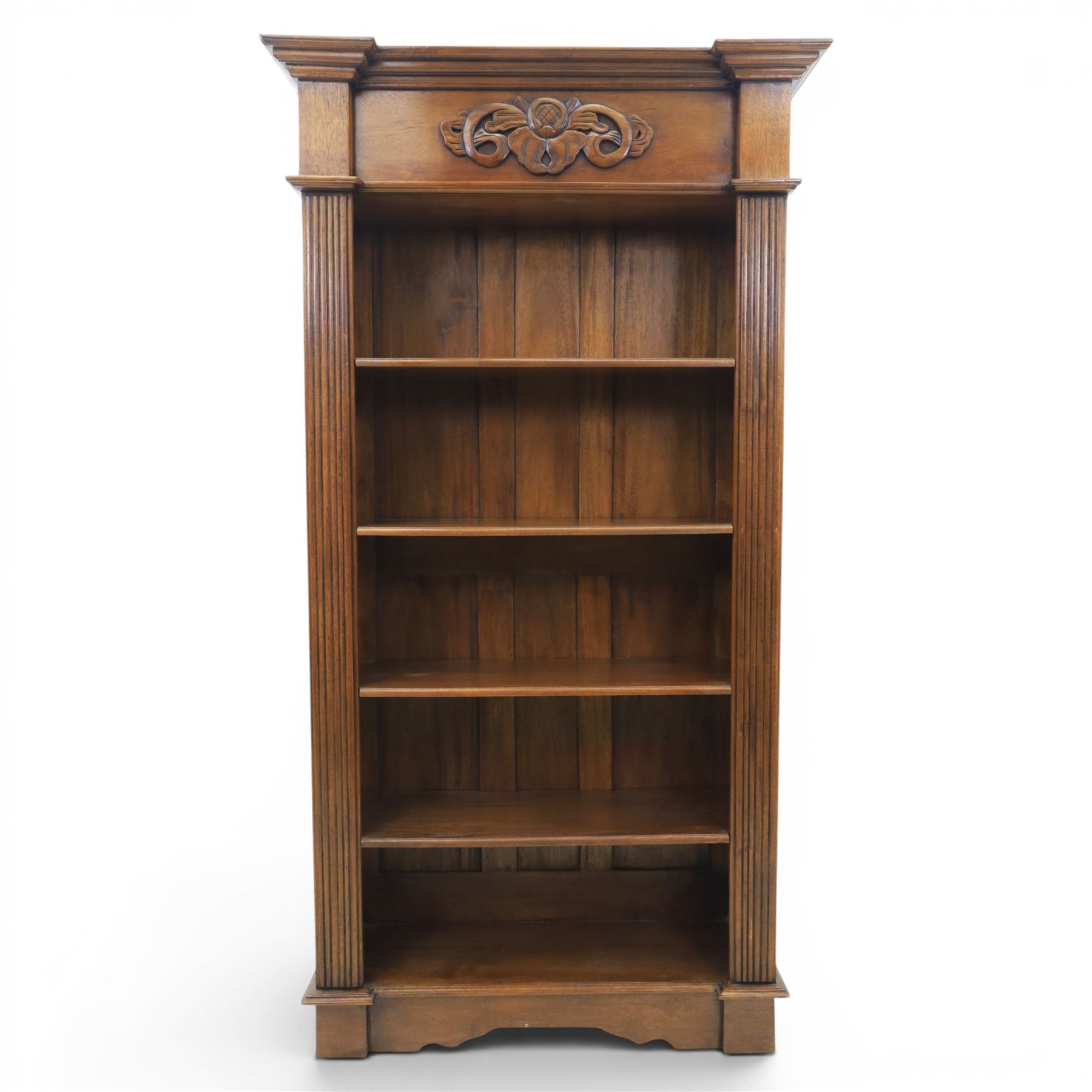 Hardwood open bookcase, fitted with five open shelves, applied carving to top facia