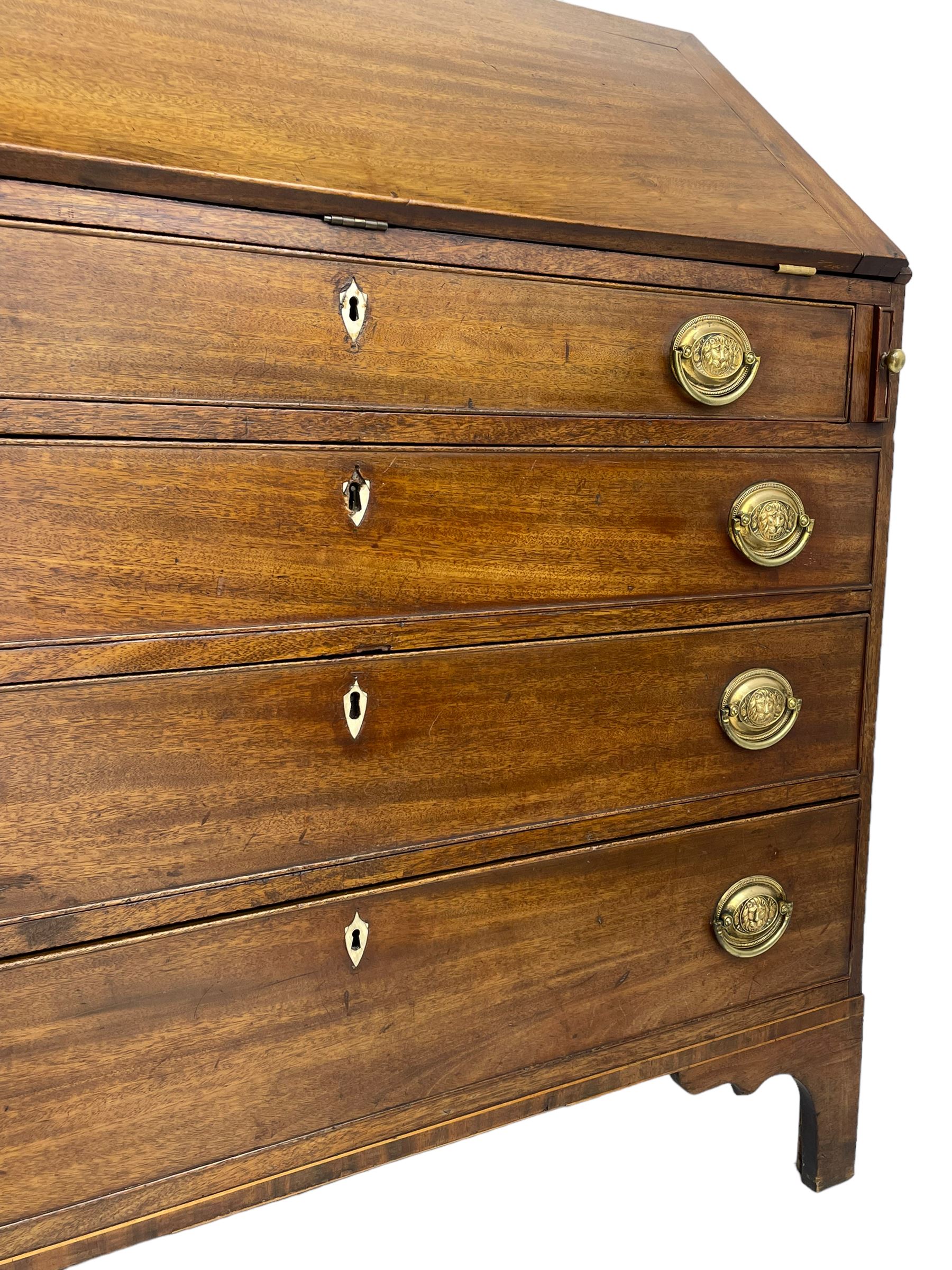 George III mahogany bureau, the fall-front banded and with boxwood stringing, enclosing fitted interior with pigeonholes and drawers surrounding a central cupboard with inlaid shell motif, the base with four graduating cock-beaded drawers, each with pressed brass handle plates with central lion masks and ivory escutcheons, on shaped bracket feet
This item has been registered for sale under Section 10 of the APHA Ivory Act