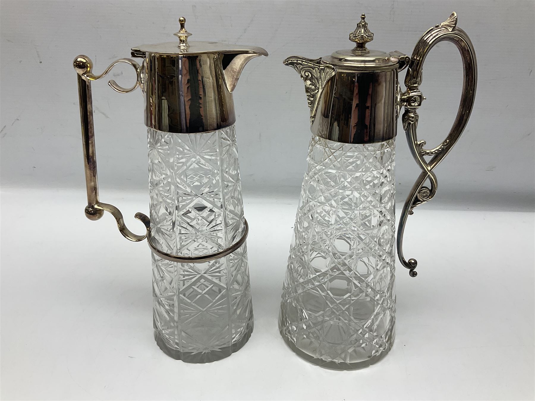 Pair of Mappin and Webb silver plate pierced pedestal bon bon dishes, together with other silver plate comprising teapot stand engraved with lion's head to centre, two cut glass claret jugs, two bottle coasters with acorn decoration, two open salts upon dolphin mounts, tea caddy, three piece cruet set and a large oval tray with pierced sides and upon four ball feet