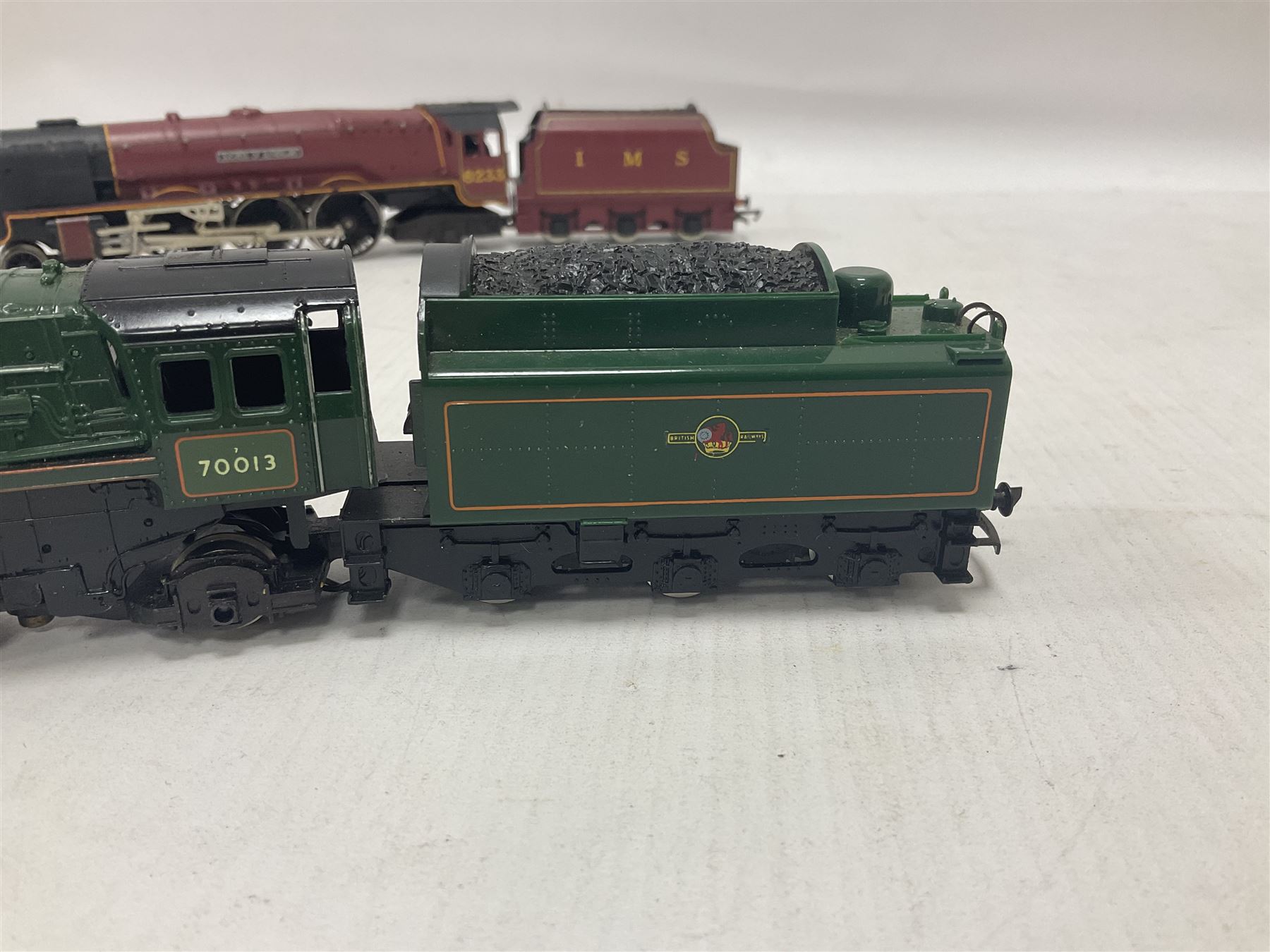 Hornby ‘00’ gauge - four steam locomotives comprising Britannia Class ‘Britannia’ 4-6-2 no.70000 in BR green; Britannia Class ‘Oliver Cromwell’ 4-6-2 no.70013 in BR green; Princess Class 4-6-2 no.6201 in LMS crimson; Coronation Class ‘Duchess of Sutherland’ 4-6-2 no.6233 in LMS crimson; one further tender (5) 