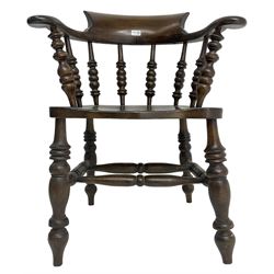 Early 20th century stained beech captains smokers bow chair, spindle tub shaped back over saddle seat, raised on turned supports united by double H-stretcher