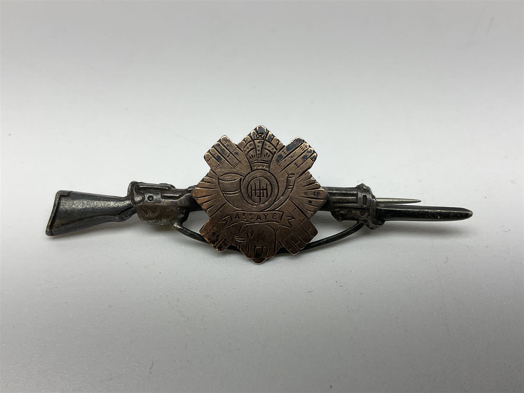 Popski's Private Army sterling silver cap badge; and two silver sweetheart brooches for Highland Light Infantry as a rifle and silver gilt Glengarry badge and Army Service Corps with blue enamel; and another silver badge (4)