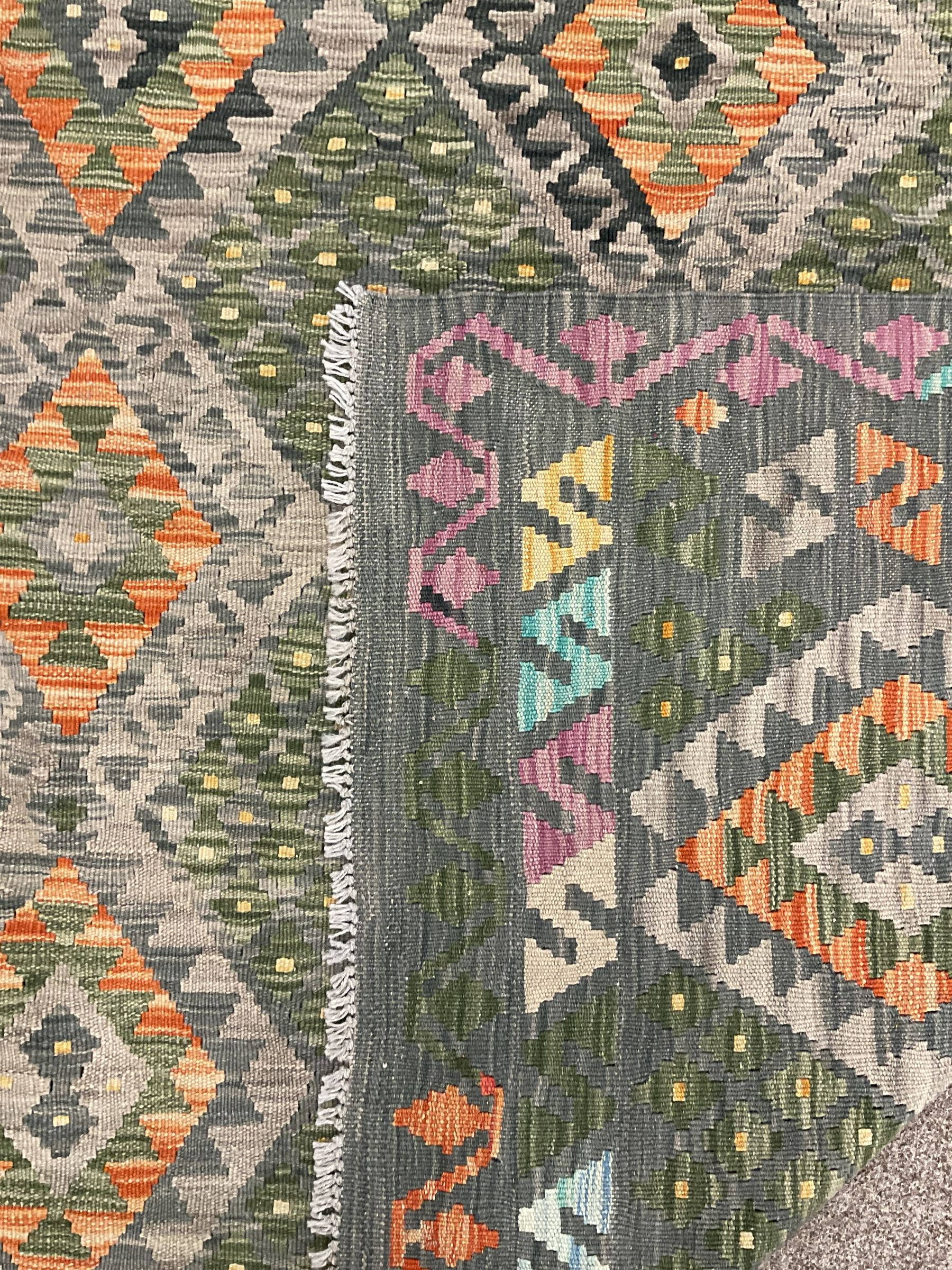 Kilim grey and green ground rug, overall geometric design decorated with lozenges