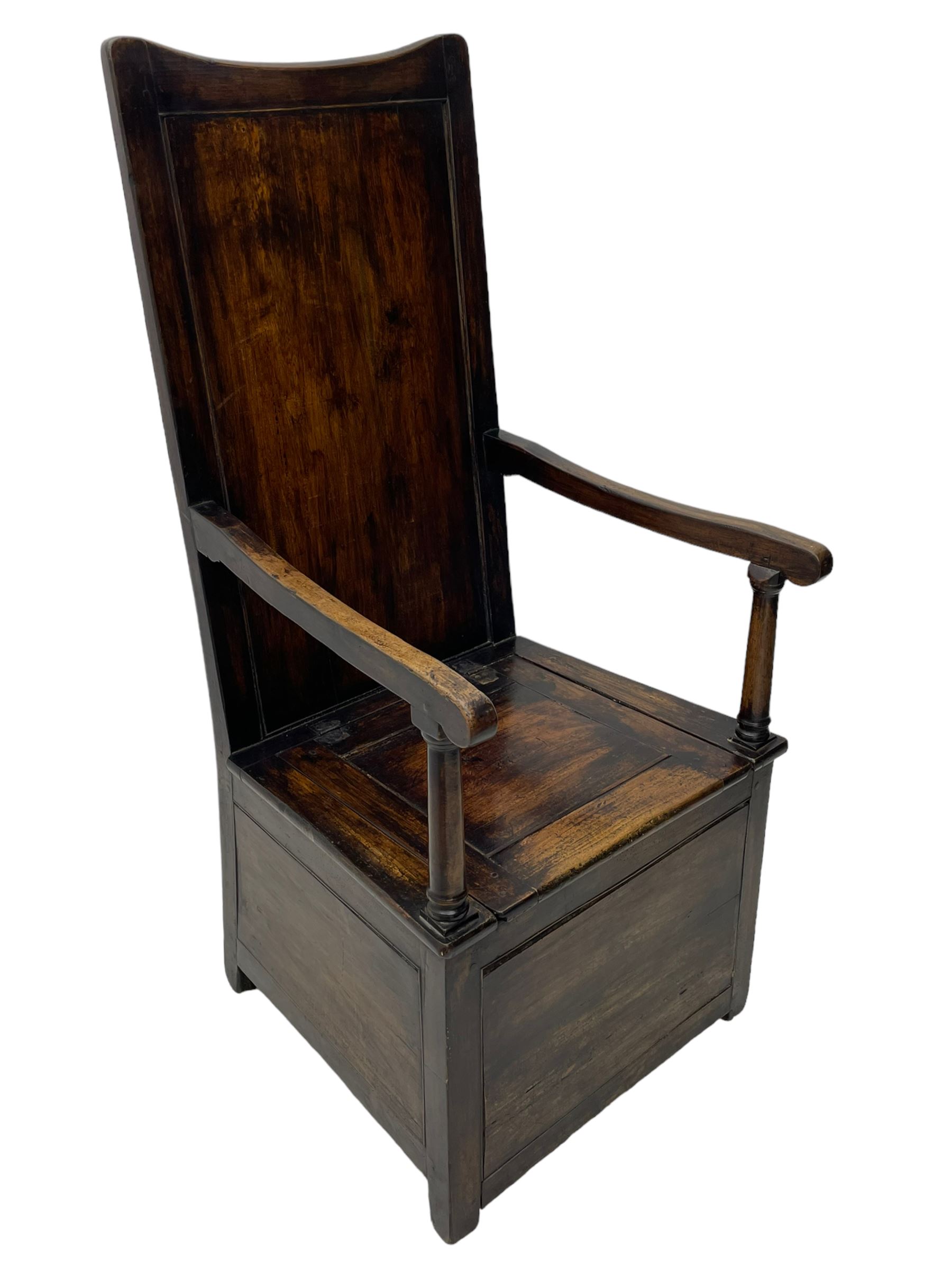 18th century elm box-seat lambing chair, dished cresting rail over panelled back, panelled hinged lid flanked by two turned arm supports