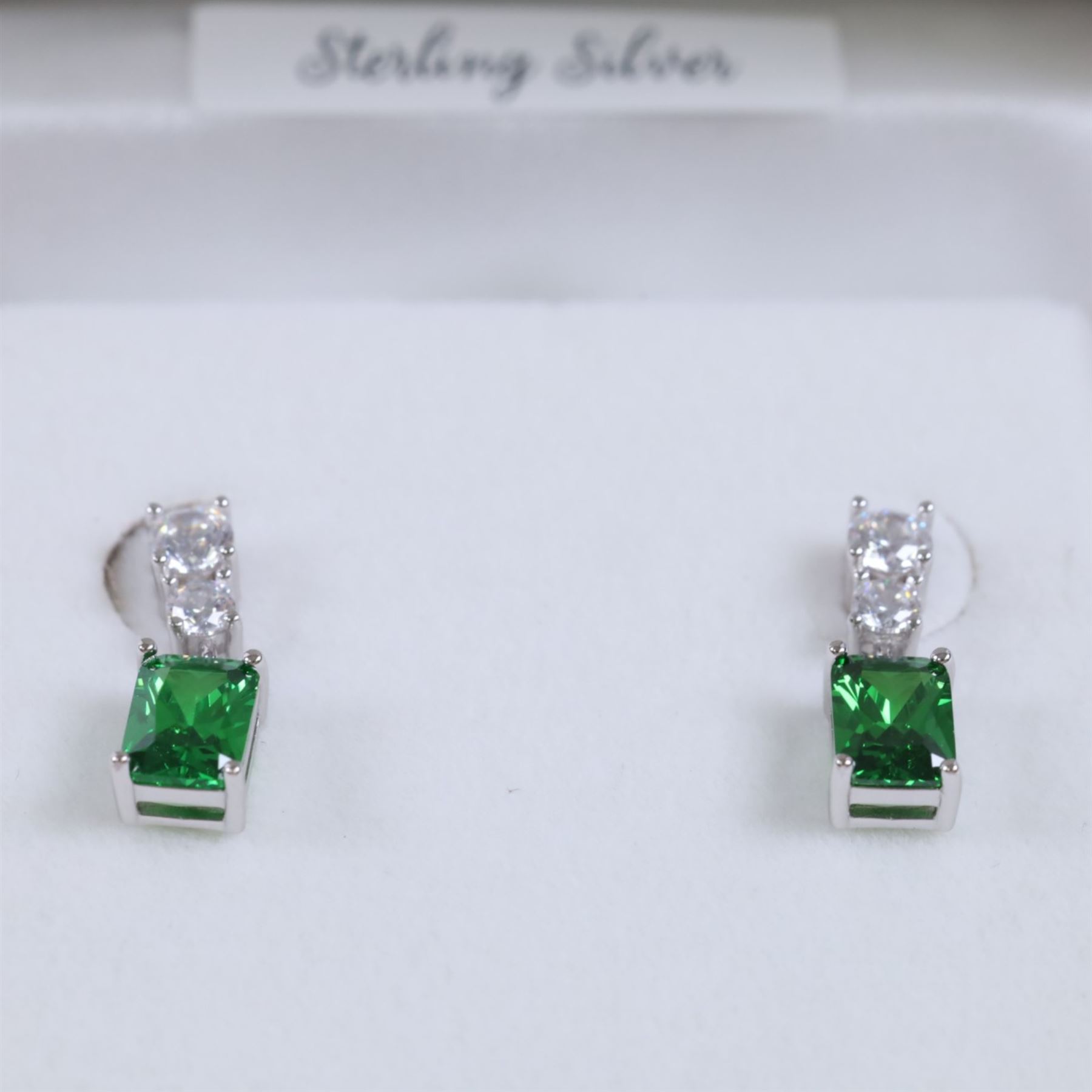 Pair of silver cubic zirconia green stone pendant earrings, boxed