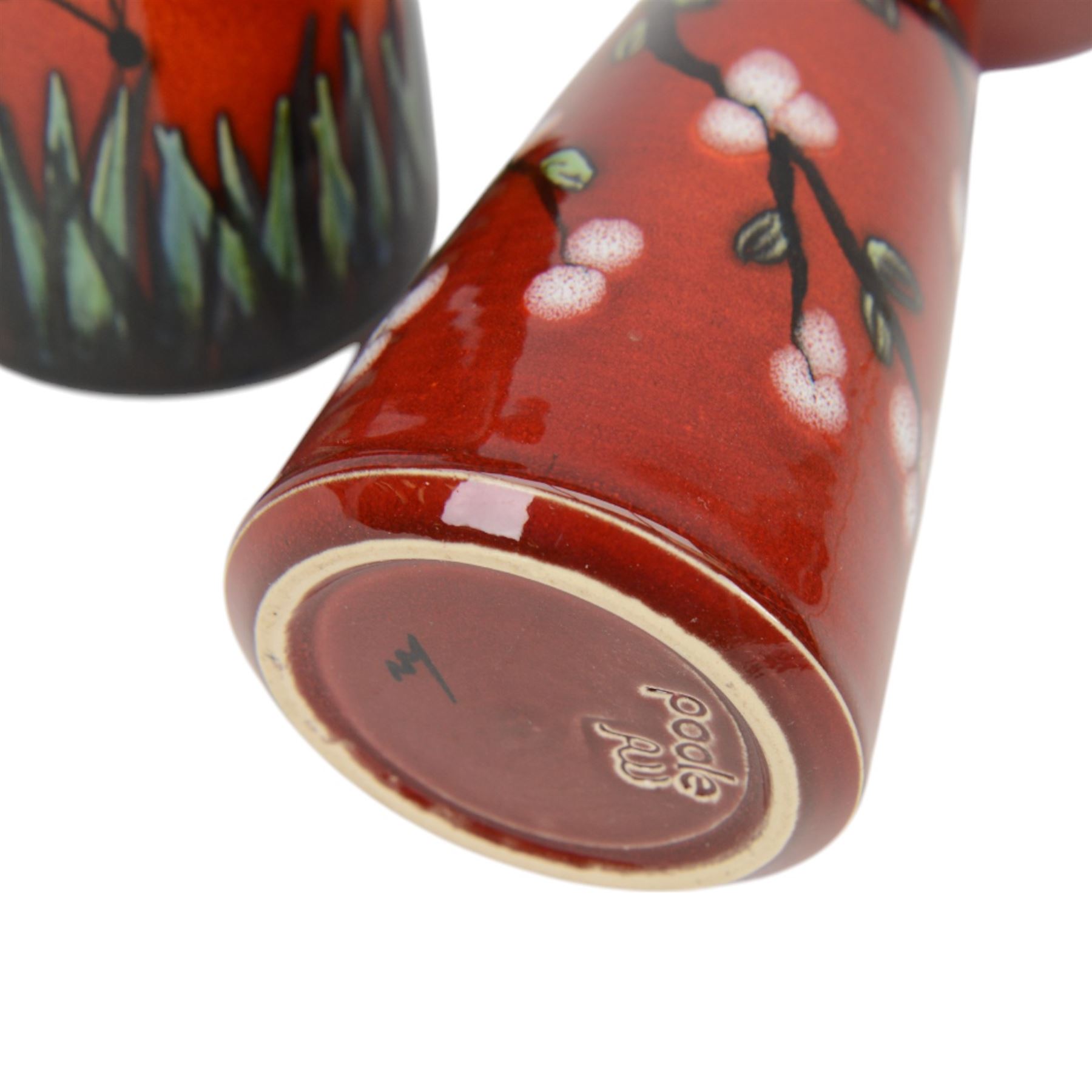 Two Poole Pottery vases decorated in Butterfly pattern, together with matching jug and another Poole Pottery vase decorated in cherry blossom