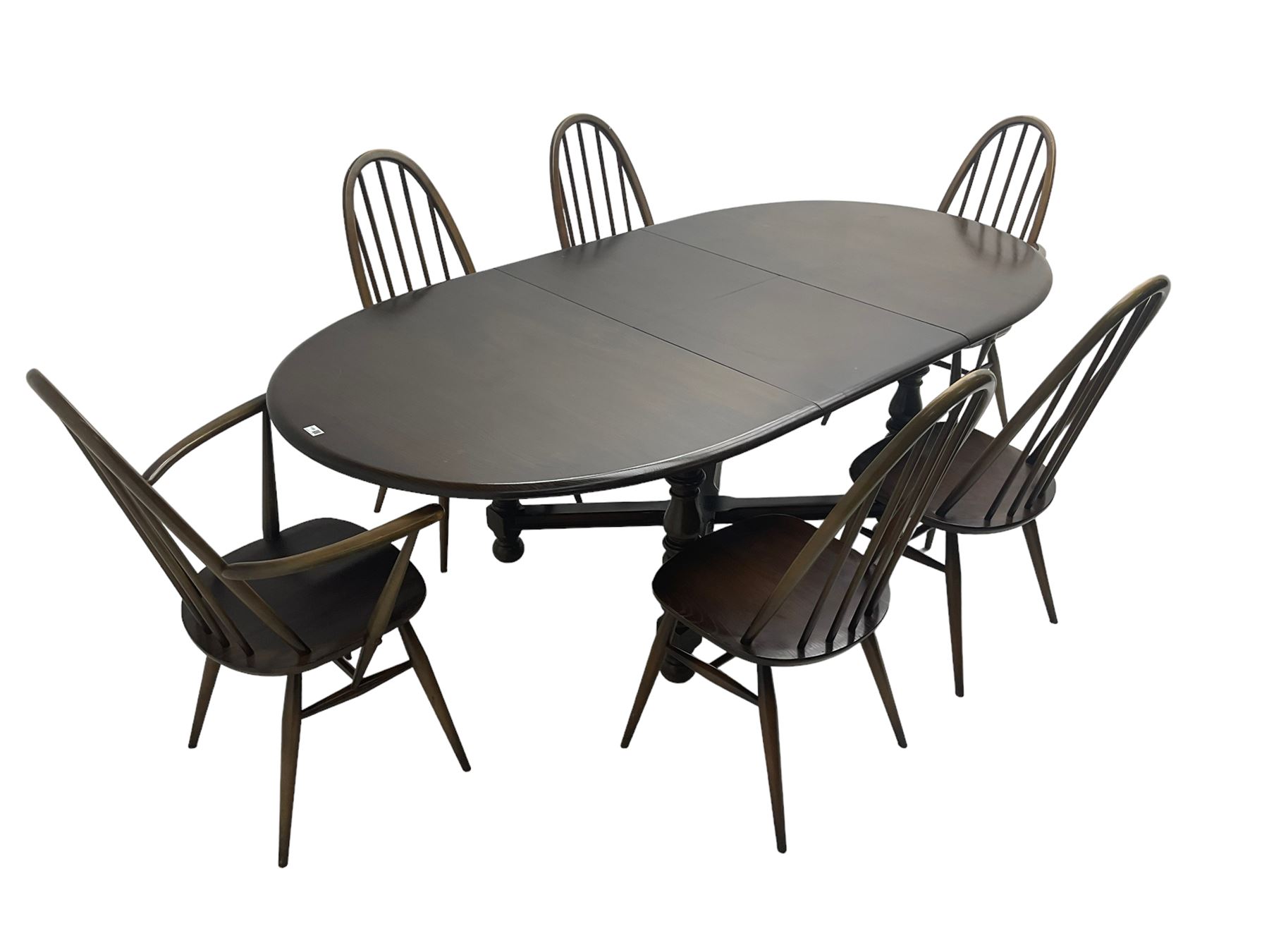 Ercol - 'Old Colonial' 705 elm extending dining table, oval top with hidden leaf, raised on turned supports united by X-stretcher (W163cm D108cm H72cm); and Ercol - set six  (4+2) dark elm 'Quaker Back Windsor Dining Chairs', hoop and stick backs 