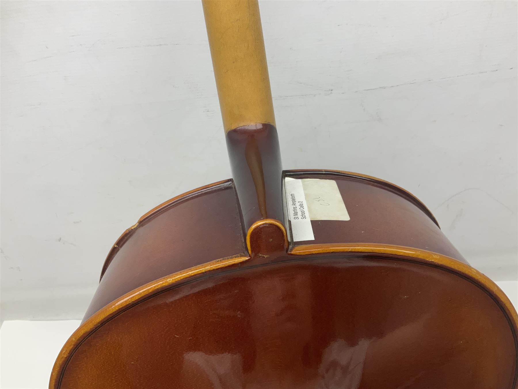 Two student half-size cellos - Boosey & Hawkes Artia with 65cm one-piece back and spruce top; bears maker's label; L104cm overall; and Romanian with 65.5cm two-piece maple back and ribs and spruce top; bears label; L108.5cm overall; each in soft carrying case with two bows (2)