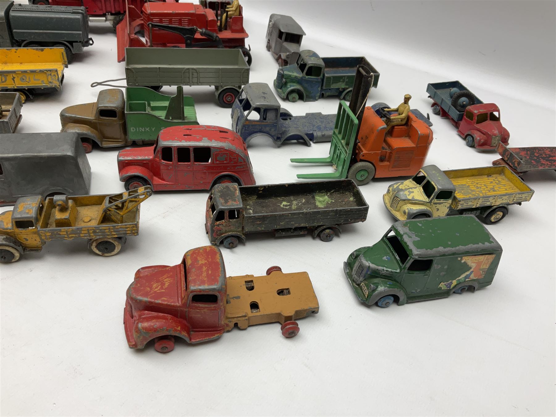 Dinky - twenty-six unboxed and playworn die-cast models including Foden Regent Tanker, two Foden lorries, Pressure Refueller No.642, Snow Plough, Elevator Loader, Foden Dump Truck, Blaw Knox Bulldozer and other commercial vehicles