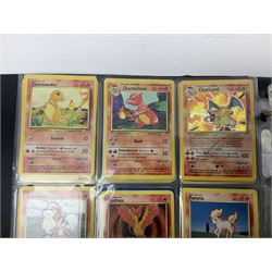 Collection of Pokemon trading cards, mostly 1999 Wizards Pokemon cards to include holo Charizard 4/102, first edition holo Machamp 8/102, further holographic cards; Dark Flareon 35/82 and Dark Vaporeon 45/82, cards from themed sets and 4th edition prints; 1998 Electronic Pokédex with cardboard boxes for themed decks Blackout, Overgrowth and Power Reserve Jungle, along with a large quantity of energy and trainer cards 