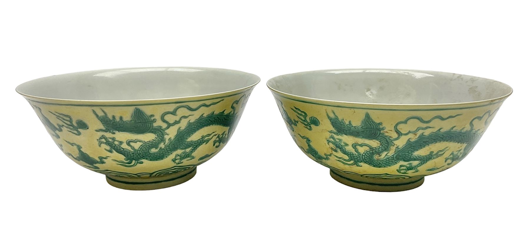 Pair of Chinese famille jaune bowls, decorated in green enamel with a dragon chasing a flaming pearl amongst clouds, upon a yellow ground, the interior decorated to centre with dragon, with six character mark beneath, D17.5cm