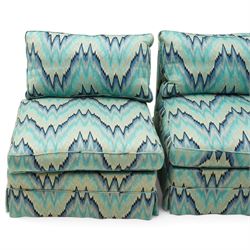 Parker & Farr - 1970s modular sofa suite comprising four chairs and footstool, reclined back with loose seat cushion, upholstered in turquoise flame-stich fabric with skirt, on castors